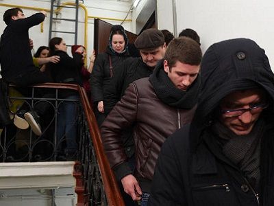 Оперативники (в капюшонах) покидают квартиру Зои Световой, 28.2.17. Фото: Василий Максимов / AFP / Scanpix / LETA
