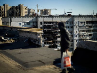 Житель харьковского района Салтовка на крыше поврежденной многоэтажки Фото: Francisco Seco / AP / Scanpix / LETA